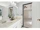 Bathroom featuring double vanity, neutral wall color, tile flooring, and door to main bedroom at 172 Shallow Ridge Ne Ln, Kennesaw, GA 30144