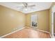 Bedroom features tan walls, ceiling fan, laminate flooring, and window views of outside greenery at 172 Shallow Ridge Ne Ln, Kennesaw, GA 30144