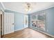 Bright bedroom featuring laminate flooring, light blue walls, a ceiling fan, and shelving to the left at 172 Shallow Ridge Ne Ln, Kennesaw, GA 30144