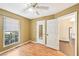 Bedroom featuring tan walls, laminate flooring, window views and access to additional rooms at 172 Shallow Ridge Ne Ln, Kennesaw, GA 30144