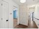 Hallway featuring accent wall, tile flooring and an entrance to a room with light blue walls at 172 Shallow Ridge Ne Ln, Kennesaw, GA 30144