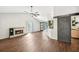 Bright living room featuring a brick fireplace, wood floors, and a unique barn door accent at 172 Shallow Ridge Ne Ln, Kennesaw, GA 30144