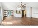 Spacious living room featuring wood floors, modern lighting, and access to the kitchen and backyard at 172 Shallow Ridge Ne Ln, Kennesaw, GA 30144