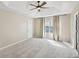 Spacious main bedroom featuring neutral walls, trey ceiling, ceiling fan, window, and carpet flooring at 172 Shallow Ridge Ne Ln, Kennesaw, GA 30144