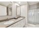 Bathroom features a double sink vanity with a glass walk-in shower at 220 Renaissance Ne Pkwy # 1205, Atlanta, GA 30308