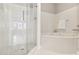 Bright bathroom features a glass walk-in shower and a large soaking tub at 220 Renaissance Ne Pkwy # 1205, Atlanta, GA 30308