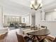 Elegant dining area open to the living room with hardwood floors and modern chandelier at 220 Renaissance Ne Pkwy # 1205, Atlanta, GA 30308