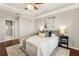 A well lit main bedroom featuring a ceiling fan, and hardwood floors at 220 Renaissance Ne Pkwy # 1205, Atlanta, GA 30308