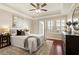 A well lit main bedroom featuring a ceiling fan, and hardwood floors at 220 Renaissance Ne Pkwy # 1205, Atlanta, GA 30308