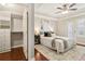 A well lit main bedroom with hardwood floors, a walk-in closet, and ceiling fan at 220 Renaissance Ne Pkwy # 1205, Atlanta, GA 30308