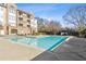 Community pool surrounded by manicured landscaping, seating, and lounge areas at 220 Renaissance Ne Pkwy # 1205, Atlanta, GA 30308