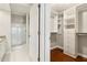 View of a walk-in closet and bathroom with custom shelving and storage options at 220 Renaissance Ne Pkwy # 1205, Atlanta, GA 30308