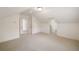 Large, finished attic with neutral carpet, doors, a window and storage space at 2374 Havenridge Nw Dr, Atlanta, GA 30305