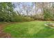 Large grassy backyard bordered by mature trees and shrubs creates a private and tranquil setting at 2374 Havenridge Nw Dr, Atlanta, GA 30305