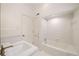 Clean bathroom with white tile, large tub and shower combination, and sink at 2374 Havenridge Nw Dr, Atlanta, GA 30305