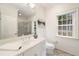 Bright bathroom featuring a white vanity, framed mirror, and walk-in tiled shower at 2374 Havenridge Nw Dr, Atlanta, GA 30305