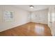 Bedroom featuring wood flooring, plantation shutters, and a neutral color scheme at 2374 Havenridge Nw Dr, Atlanta, GA 30305