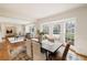 Bright dining room featuring hardwood floors, a large bay window, and elegant decor in an open-concept space at 2374 Havenridge Nw Dr, Atlanta, GA 30305