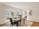 Dining room featuring hardwood floors, a large bay window, heron artwork, and elegant decor at 2374 Havenridge Nw Dr, Atlanta, GA 30305