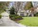 A charming white brick home with a detached garage and a well-maintained lawn and stone-lined driveway at 2374 Havenridge Nw Dr, Atlanta, GA 30305