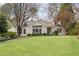 Traditional white brick home with a manicured lawn and mature trees providing shade and curb appeal at 2374 Havenridge Nw Dr, Atlanta, GA 30305