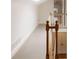 Upstairs hallway featuring wood trim, a staircase, and linen closet at 2374 Havenridge Nw Dr, Atlanta, GA 30305