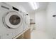 Bright laundry room with modern Miele washer and dryer on a raised platform at 2374 Havenridge Nw Dr, Atlanta, GA 30305