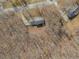 An aerial view of a single Gathering home surrounded by a wooded area featuring a long driveway and second building at 4260 Laurel Glen Ct, Douglasville, GA 30135