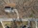 Aerial view of the home surrounded by trees, featuring a long driveway and a well-maintained yard at 4260 Laurel Glen Ct, Douglasville, GA 30135