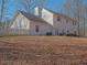 The backyard has a white picket fence, a grassy area, and mature trees surrounding the property at 4260 Laurel Glen Ct, Douglasville, GA 30135