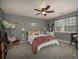 Comfortable bedroom with soft carpet, ceiling fan, and natural light creating a relaxing atmosphere at 4260 Laurel Glen Ct, Douglasville, GA 30135