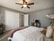 Well-lit bedroom featuring neutral walls, plush carpet, and a cozy seating area with a colorful throw pillow at 4260 Laurel Glen Ct, Douglasville, GA 30135