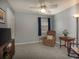 Bright bedroom featuring neutral carpet, accent chair, a window, and comfortable reading nook at 4260 Laurel Glen Ct, Douglasville, GA 30135