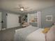 Spacious bedroom featuring a ceiling fan, plush carpet, and a bright window with white ruffled curtains at 4260 Laurel Glen Ct, Douglasville, GA 30135