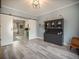 Open dining room featuring gray flooring, sliding barn doors, and a black china cabinet at 4260 Laurel Glen Ct, Douglasville, GA 30135