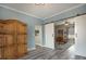 Dining room with wood cabinet, gray flooring, and sliding barn doors leading to study at 4260 Laurel Glen Ct, Douglasville, GA 30135