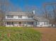 Charming two-story home with a covered front porch, a red front door, and a well-manicured lawn at 4260 Laurel Glen Ct, Douglasville, GA 30135