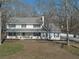 Traditional home with a front porch and black shutters, surrounded by trees and landscaping at 4260 Laurel Glen Ct, Douglasville, GA 30135