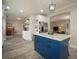 Well-appointed kitchen area with a blue island, stainless steel refrigerator, and wood-look floors at 4260 Laurel Glen Ct, Douglasville, GA 30135