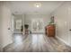 Bright living room featuring French doors leading to outdoor patio, desk, and wood-look floors at 4260 Laurel Glen Ct, Douglasville, GA 30135