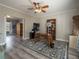 Comfortable study with gray flooring, ceiling fan, bookshelves, and a computer at 4260 Laurel Glen Ct, Douglasville, GA 30135