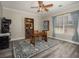 Cozy study with gray flooring, ceiling fan, bookshelves, and natural light at 4260 Laurel Glen Ct, Douglasville, GA 30135