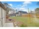 Expansive backyard with green lawn, fence, and patio seating area at 4910 Hunters Oaks Ln, Alpharetta, GA 30009