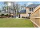 Backyard view featuring a well-maintained lawn, fence, and patio area with outdoor seating at 4910 Hunters Oaks Ln, Alpharetta, GA 30009