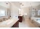 Bright bathroom with double vanity, soaking tub, and glass-enclosed shower at 4910 Hunters Oaks Ln, Alpharetta, GA 30009