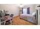 Bedroom with hardwood floors, ample sunlight, and a desk at 4910 Hunters Oaks Ln, Alpharetta, GA 30009