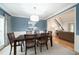 Elegant dining room with a large table, blue accent wall, white trim, and hardwood floors at 4910 Hunters Oaks Ln, Alpharetta, GA 30009