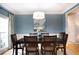 Cozy dining room featuring a classic table set, blue wallpaper accent wall and bright window at 4910 Hunters Oaks Ln, Alpharetta, GA 30009