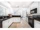 Well-lit kitchen with black countertops, white cabinets, and modern appliances at 4910 Hunters Oaks Ln, Alpharetta, GA 30009