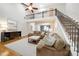 A spacious living room features an open staircase, balcony, and hardwood floors at 4910 Hunters Oaks Ln, Alpharetta, GA 30009